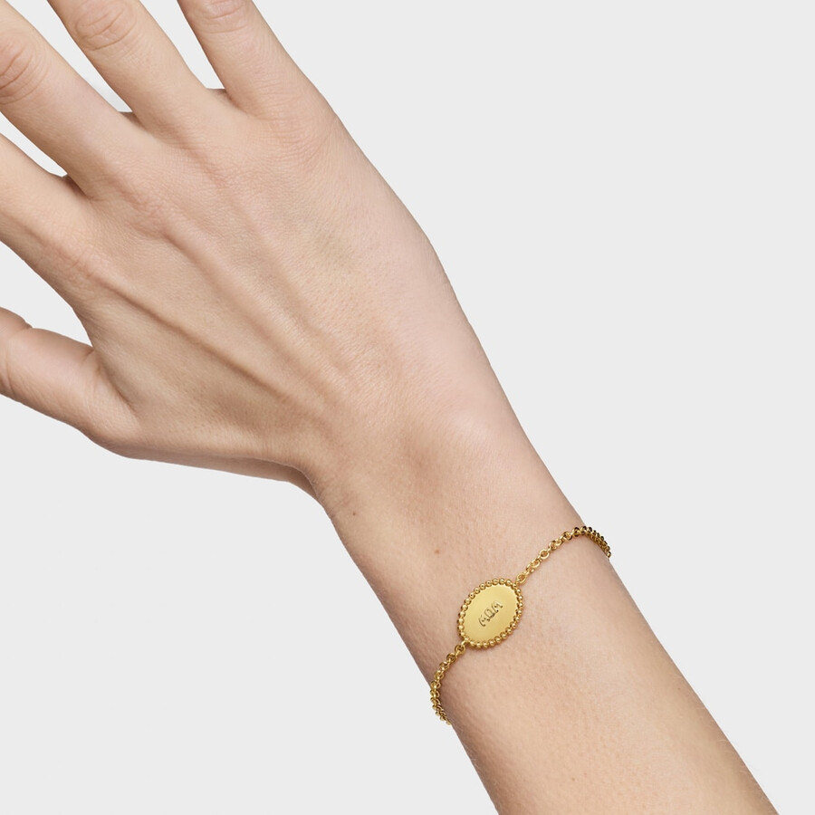 armband aus 18-karätigem gold über einer silberkette mit plakette tous mom