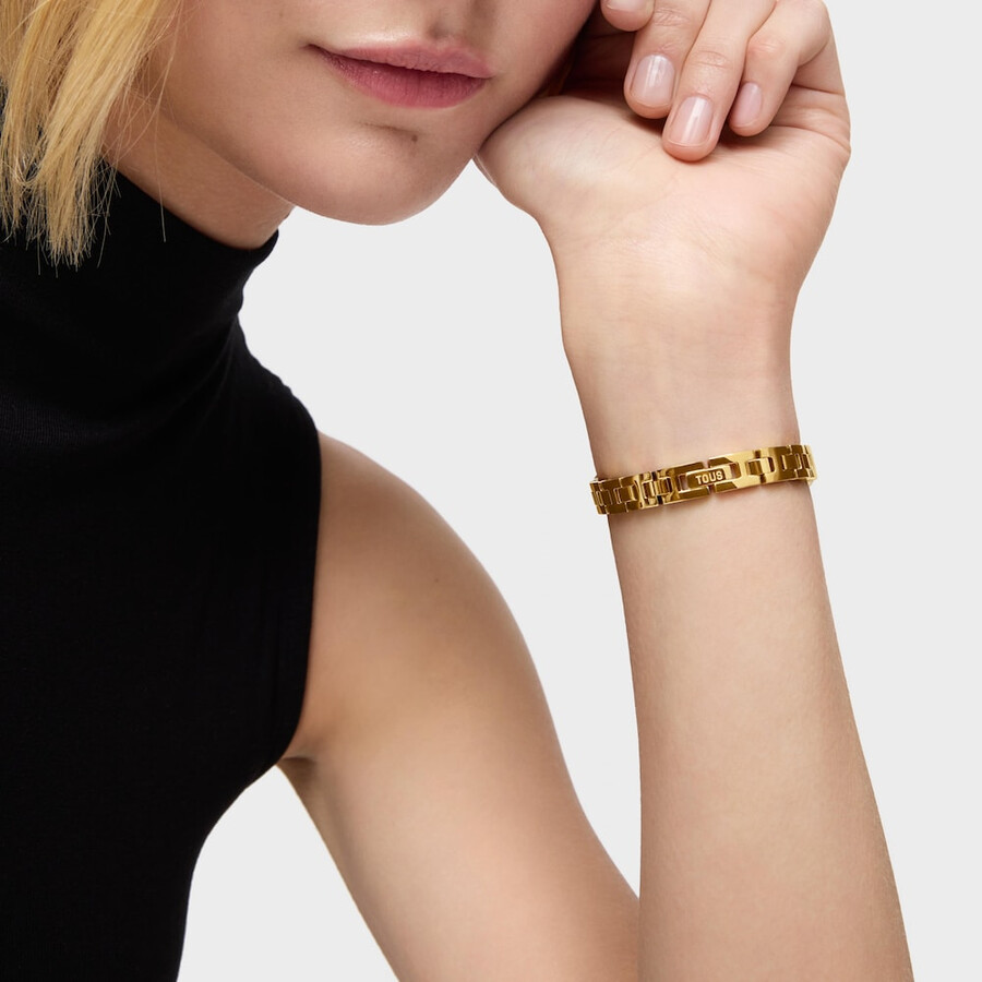 analoge armbanduhr mit schmucksteinen und goldfarbenem stahlarmband ovale zeitzone