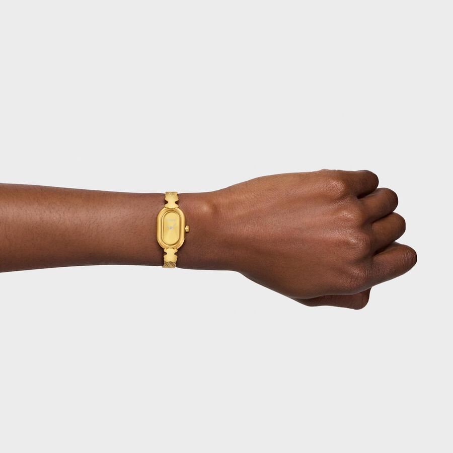 schmuckbesetzte analoge armbanduhr mit goldfarbenem stahlarmband ovales symbol